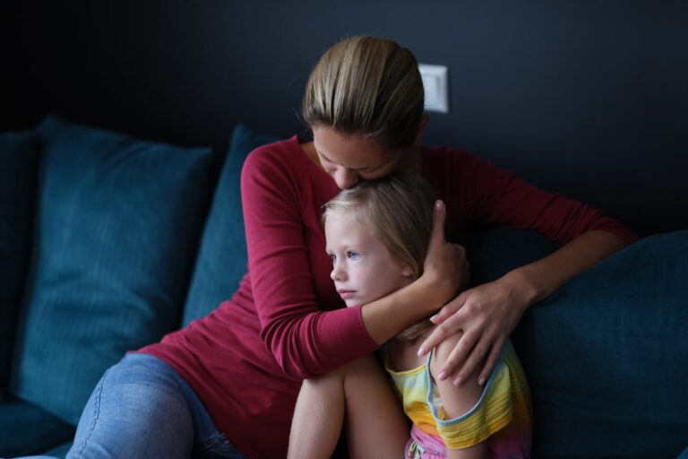 child being comforted by mother